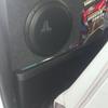 Preloaded subwoofer by JL Audio behind truck seat